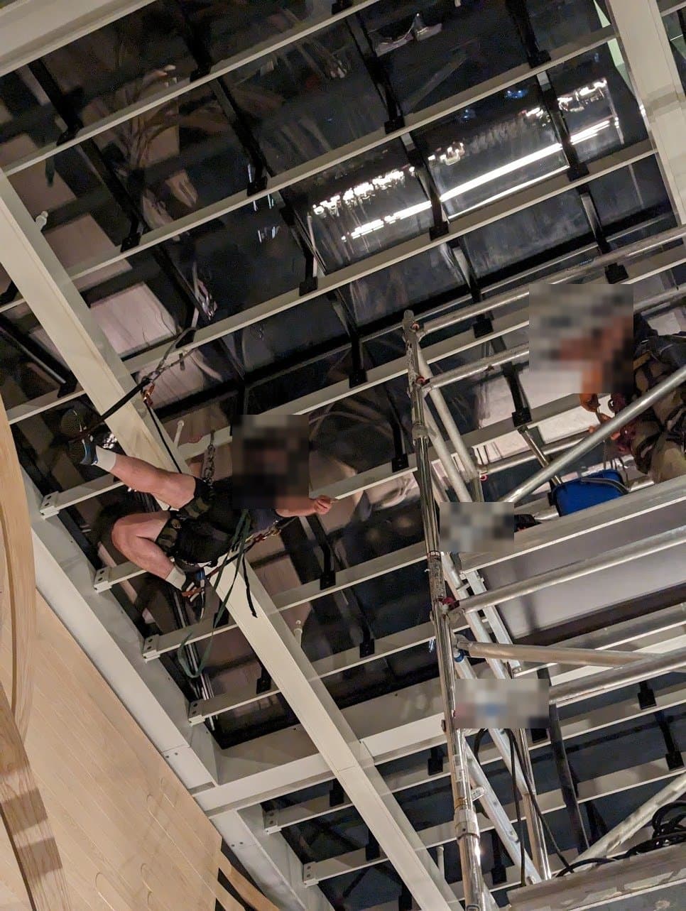 Rope access under the rooflight while a colleague works from the mobile tower