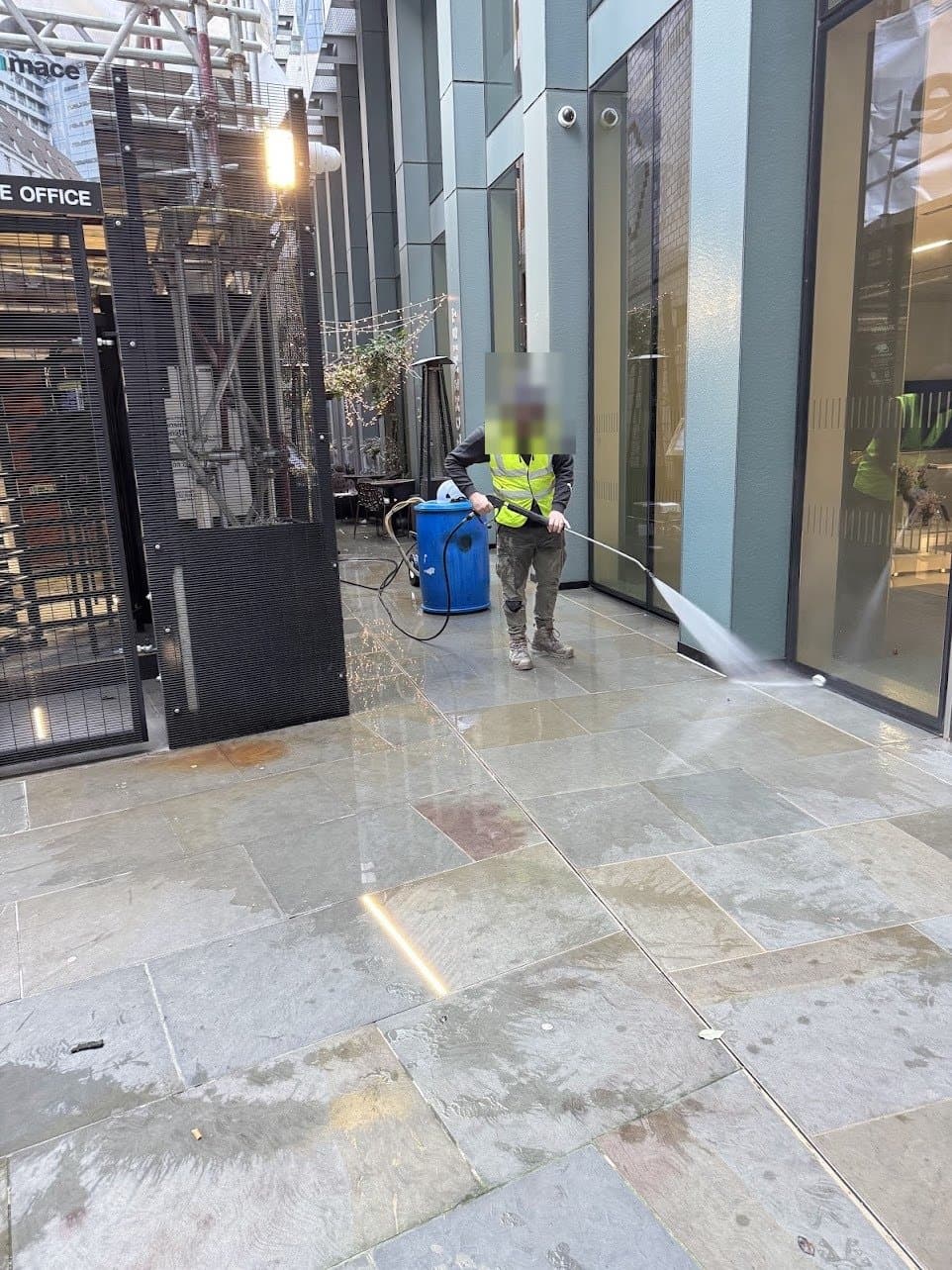 Jet washing the main entrance paving inside the live Mace site