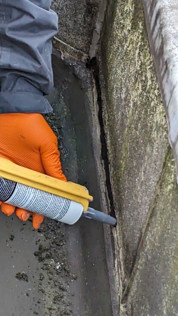 Sealant applied to the gutter joint with a gun